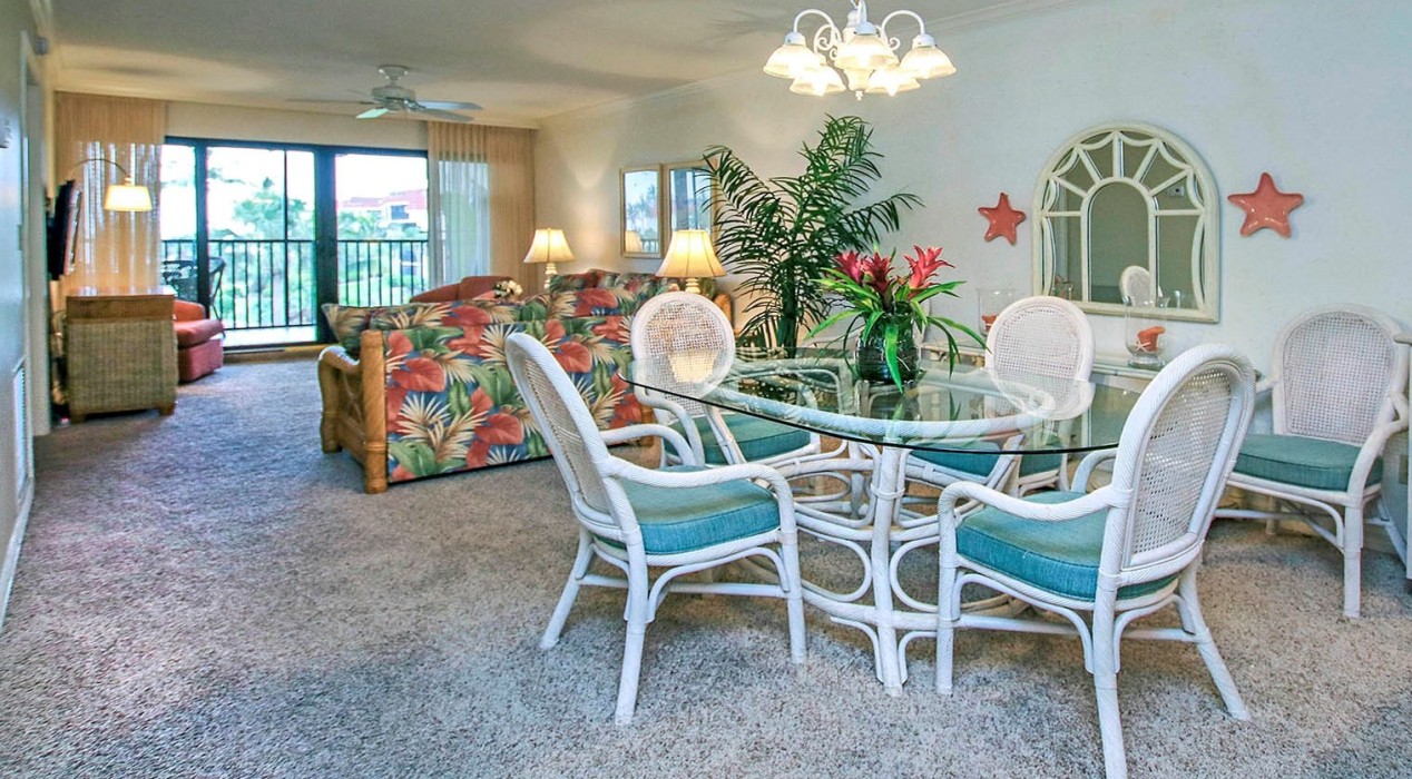 The dining area seats 6 comfortably.  Two adjacent wicker stools under the kitchen counter, and 2 chairs under the kitchen island, provide extra seating.