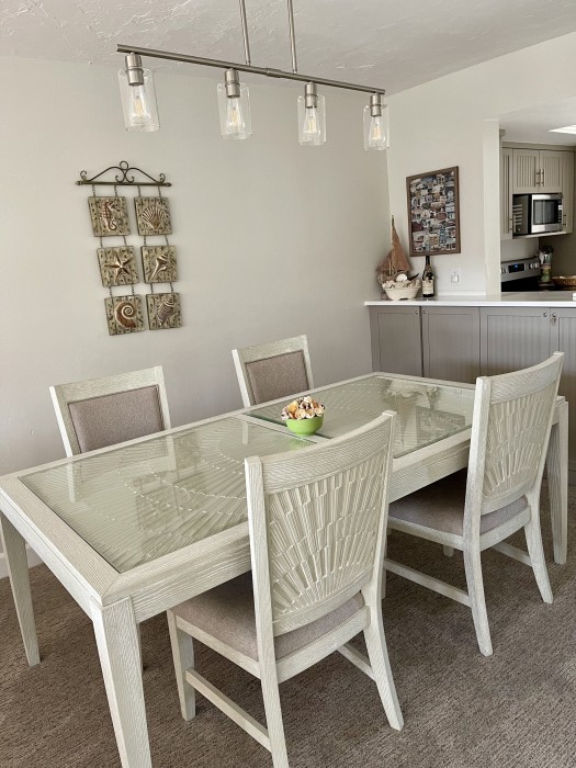 Dining table for six and 3-4 at kitchen island.