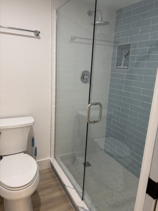 Primary bathroom - Walk in custom tiled shower.