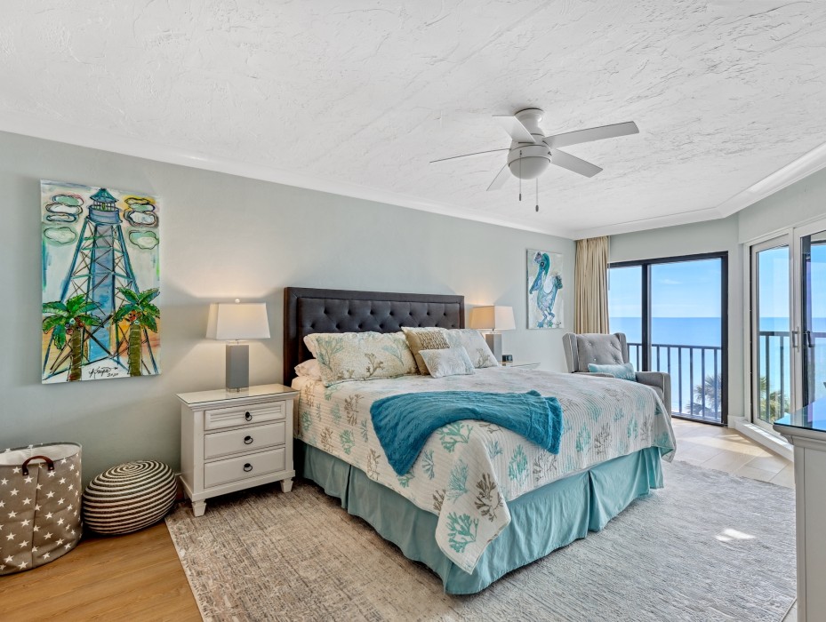 King bed in master bedroom with beach and lanai views